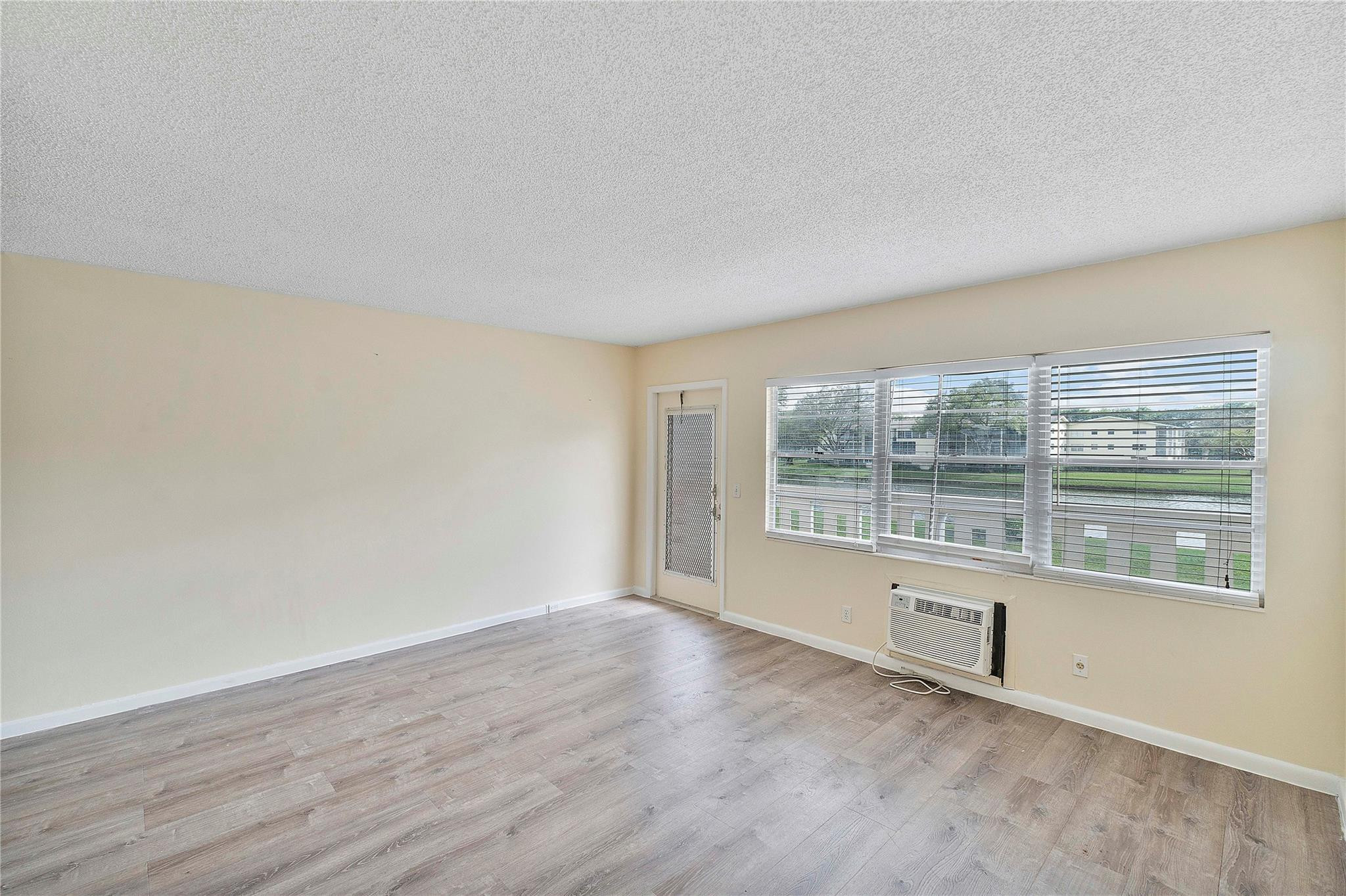 358 Dorset I, Unit 358 Boca Raton, FL 33434 - Photo 5 of 12 a view of an empty room with a window