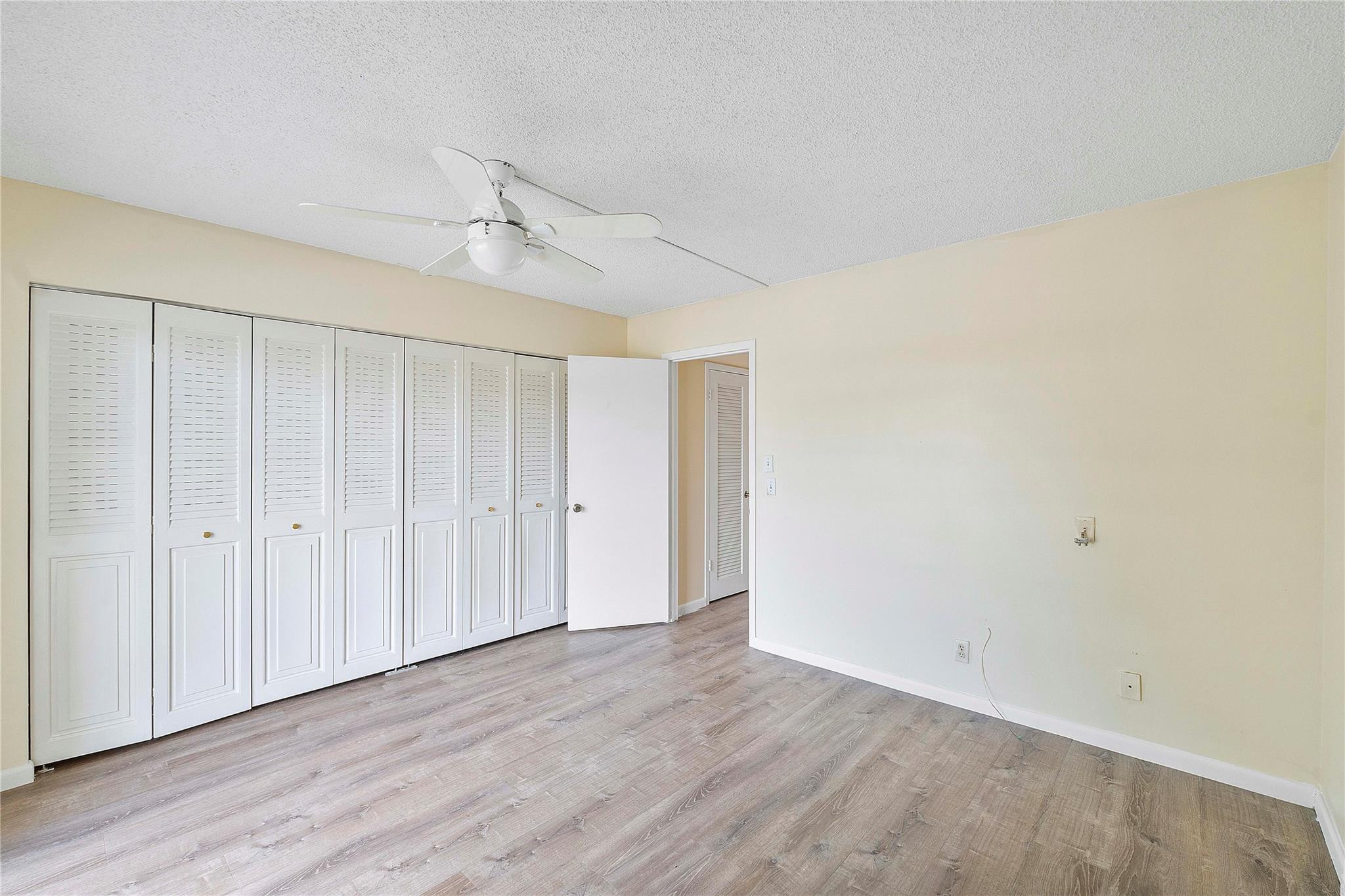 358 Dorset I, Unit 358 Boca Raton, FL 33434 - Photo 7 of 12 a view of an empty room with wooden floor