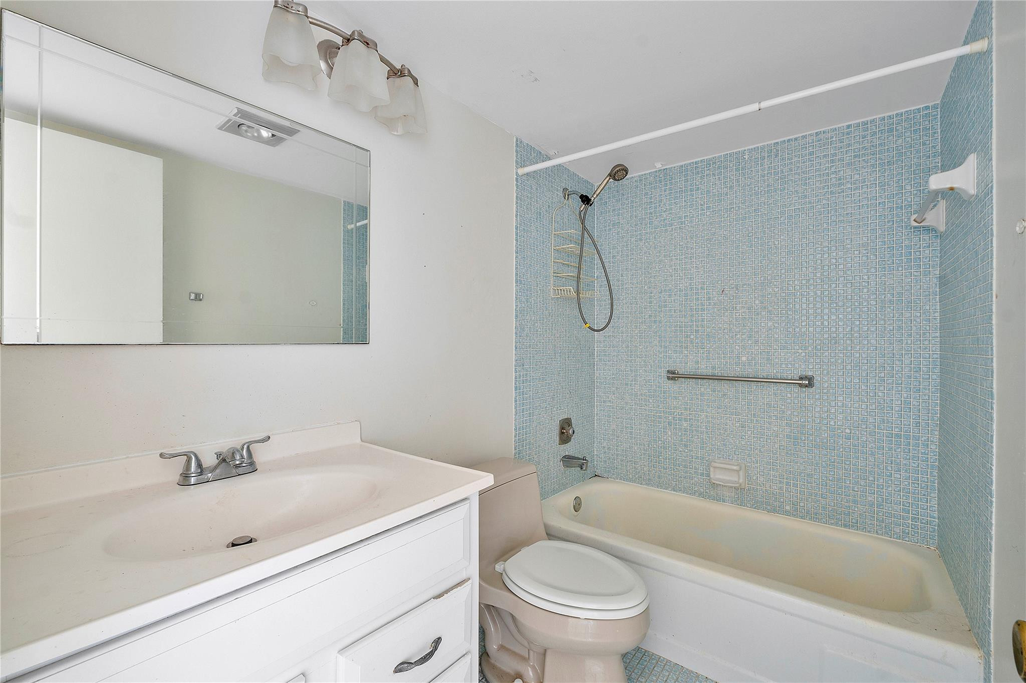 358 Dorset I, Unit 358 Boca Raton, FL 33434 - Photo 9 of 12 a bathroom with a sink toilet tub vanity and shower