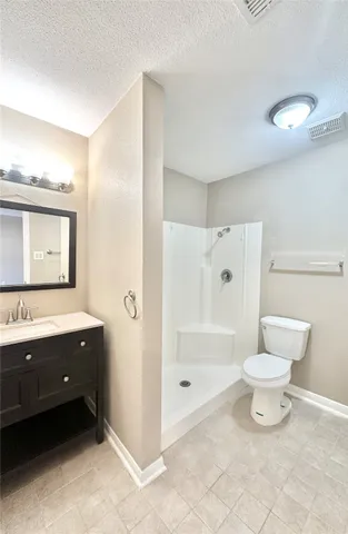 a bathroom with a toilet a sink and a mirror