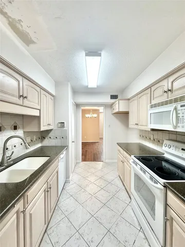 a kitchen that has a sink and a stove