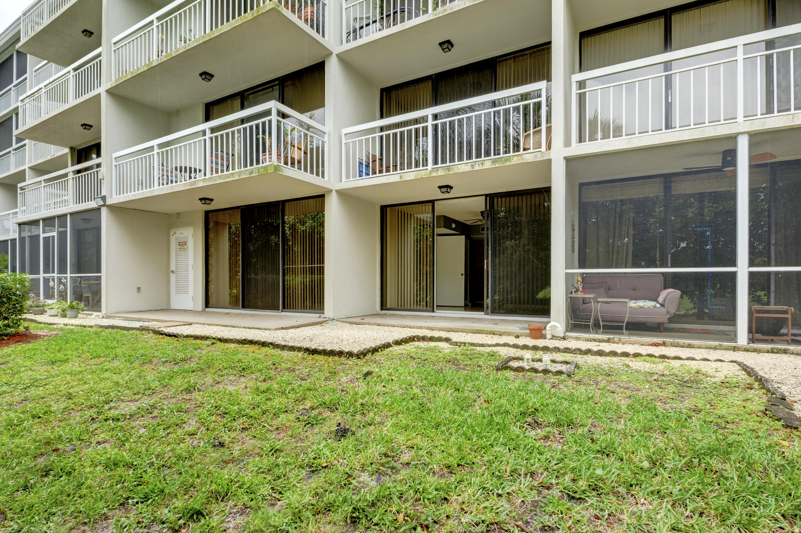 6145 Balboa Circle, Unit 103 Boca Raton, FL 33433 - Photo 25 of 31 a view of a house with backyard and porch