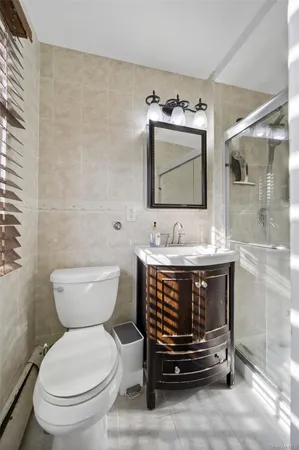 a bathroom with a sink toilet and mirror