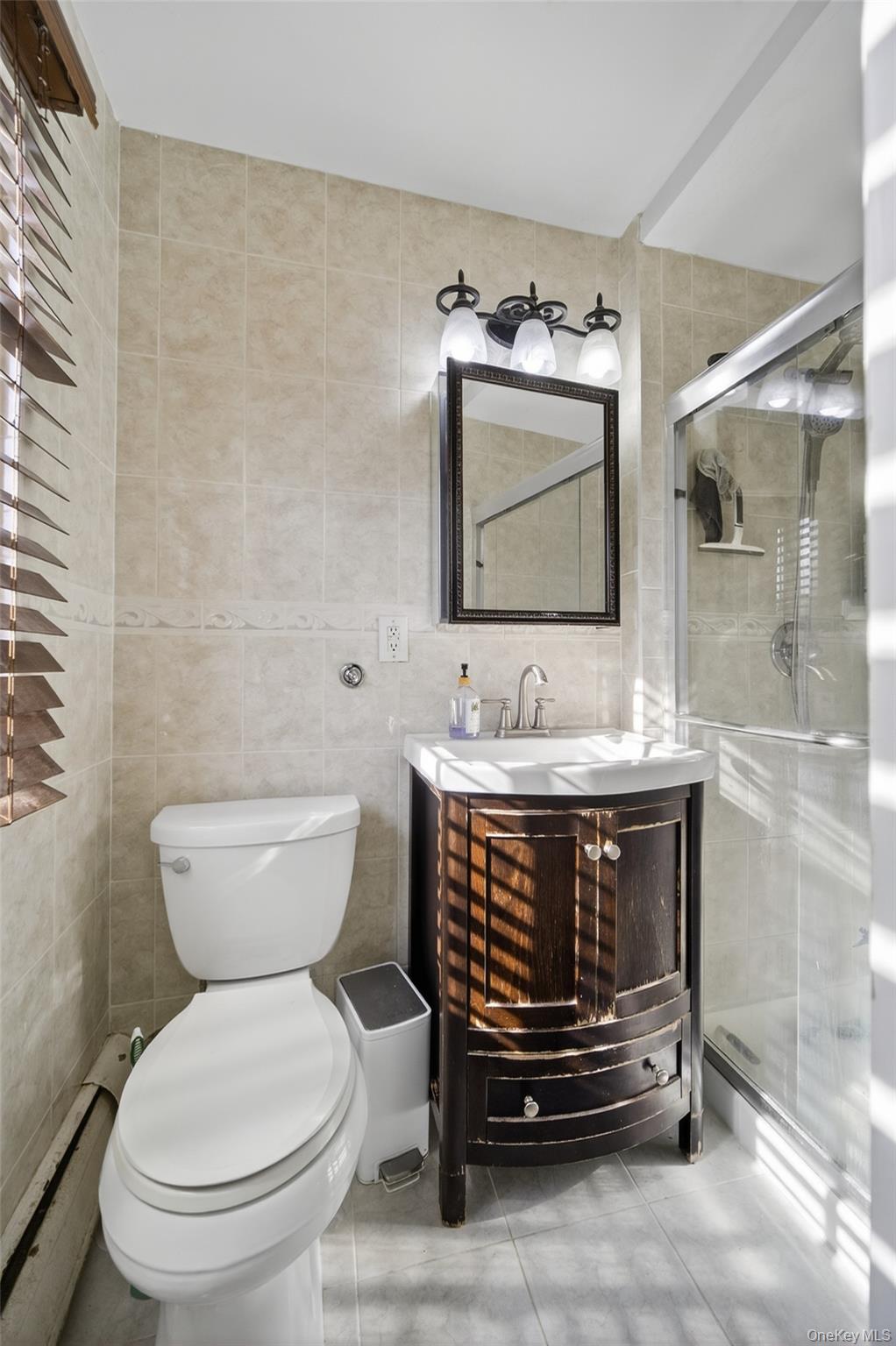 4 Secora, Unit E2 Monsey, NY 10952 - Photo 13 of 24 a bathroom with a sink toilet and mirror