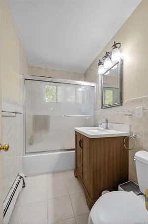 a bathroom with a sink mirror vanity and toilet