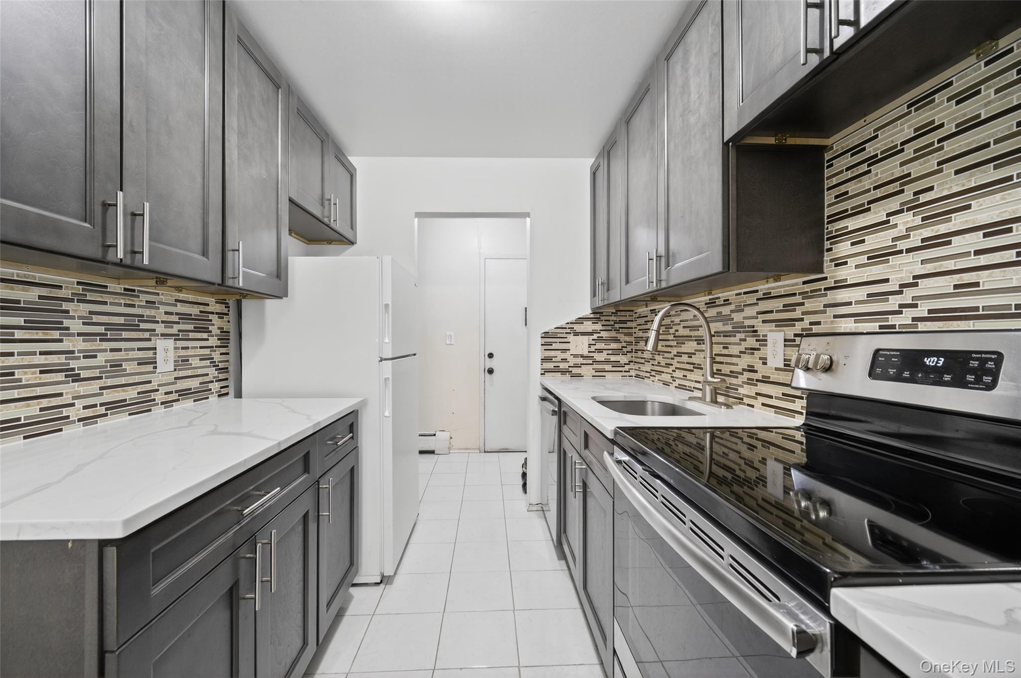 4 Secora, Unit E2 Monsey, NY 10952 - Photo 3 of 24 a kitchen with a stove and a microwave