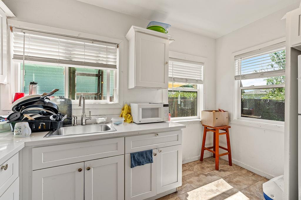 1205 Grand Avenue Santa Rosa, CA 95404 - Photo 24 of 27 a kitchen with a sink a window and chairs