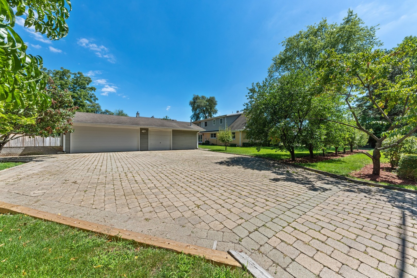 3080 Koepke Road Northbrook, IL 60062 - Photo 45 of 66 a front view of a house with a yard and a garage