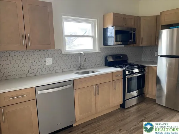 a kitchen with a sink stove and microwave