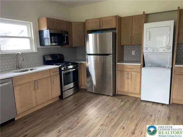 a kitchen with a refrigerator sink and microwave