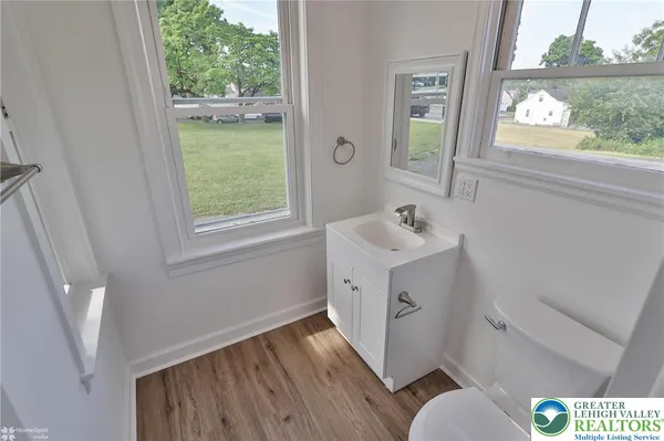 a bathroom with a sink and a window