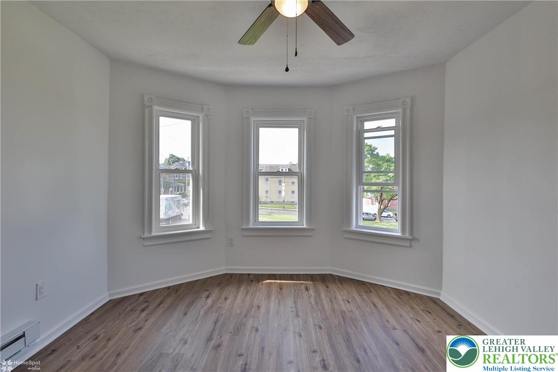 1660 Main Street Hellertown, PA 18055 - Photo 18 of 30 a view of an empty room with wooden floor and a window