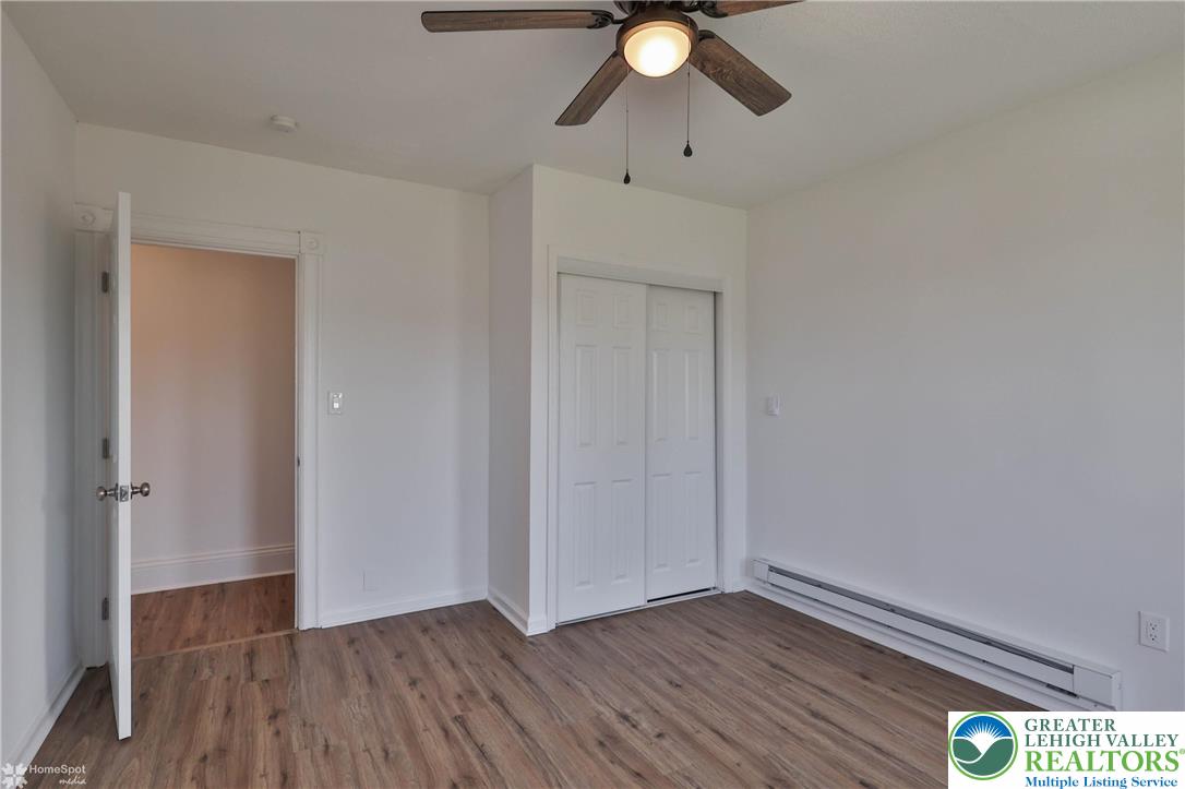 1660 Main Street Hellertown, PA 18055 - Photo 19 of 30 an empty room with wooden floor and mirror