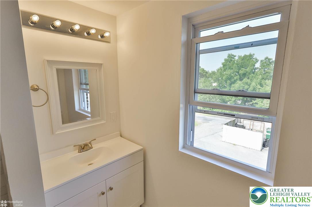 1660 Main Street Hellertown, PA 18055 - Photo 21 of 30 a bathroom with a sink a mirror and a window