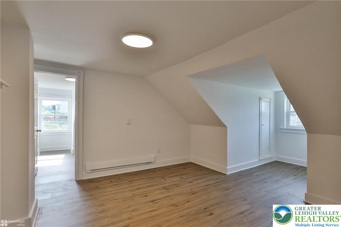 1660 Main Street Hellertown, PA 18055 - Photo 22 of 30 a view of an empty room with wooden floor and a window