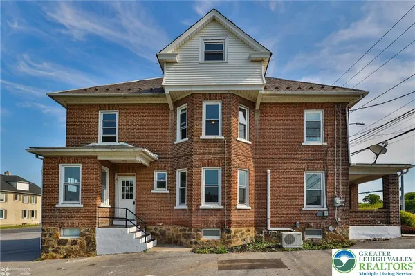 a front view of a house with glass windows