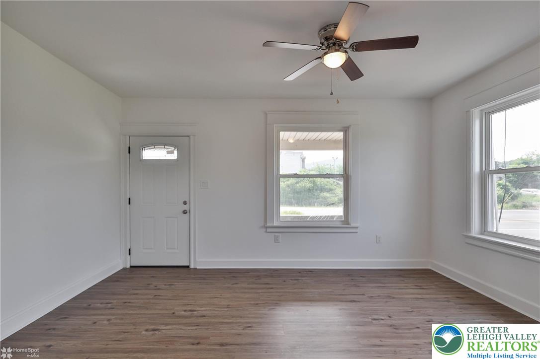 1660 Main Street Hellertown, PA 18055 - Photo 6 of 30 a view of an empty room with wooden floor and a window