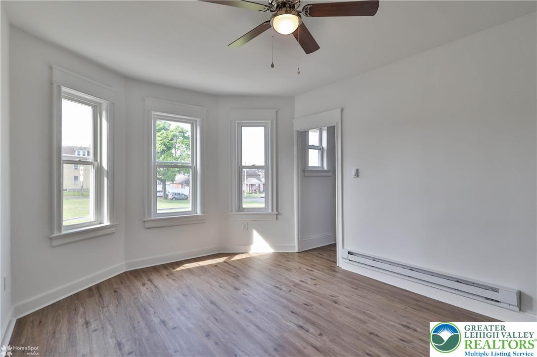1660 Main Street Hellertown, PA 18055 - Photo 7 of 30 a view of an empty room with wooden floor and window