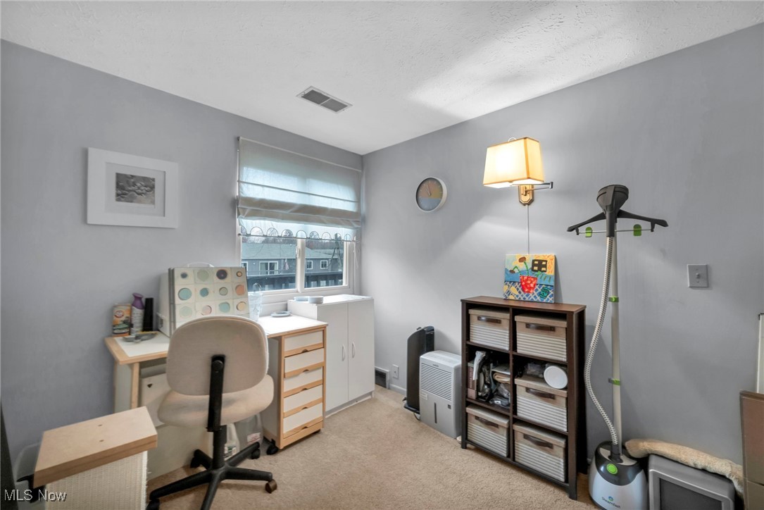 4750 Oak Point Road, Unit 304 Lorain, OH 44053 - Photo 27 of 29 Office area with light colored carpet and a textured ceiling