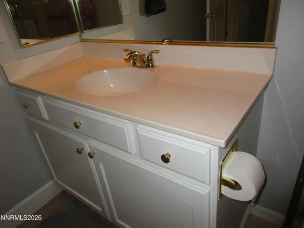 a spacious bedroom with a bed and a chandelier