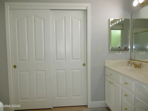 a white bath tub sitting next to a white cabinet