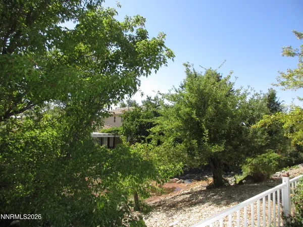a view of a house with a tree in the background