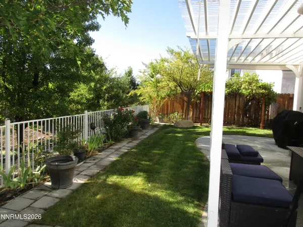a view of a backyard with plants and garden