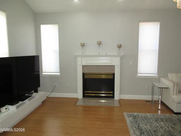 a living room with furniture a chandelier and a flat screen tv