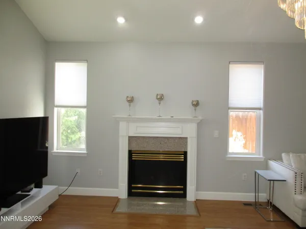 a large white kitchen with stainless steel appliances granite countertop a refrigerator and a stove