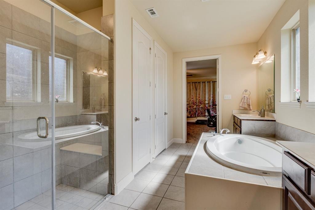 336 Red Hill Road Sunnyvale, TX 75182 - Photo 21 of 36 a bathroom with a sink double vanity granite tub shower and mirror