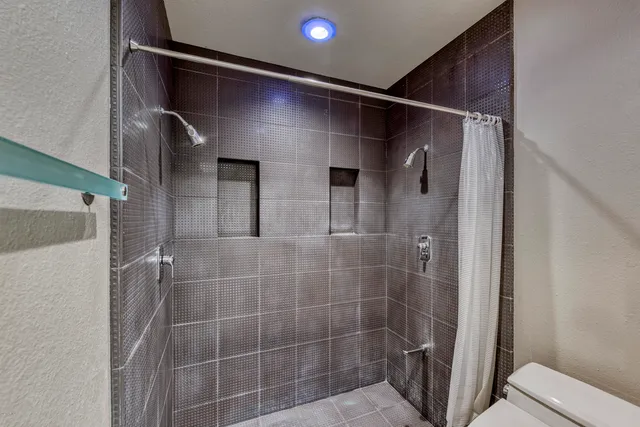 a bathroom with a shower and a toilet