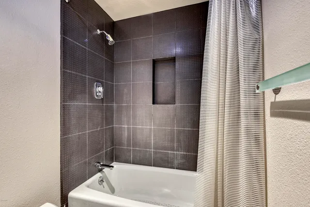 a bathroom with a bathtub and shower
