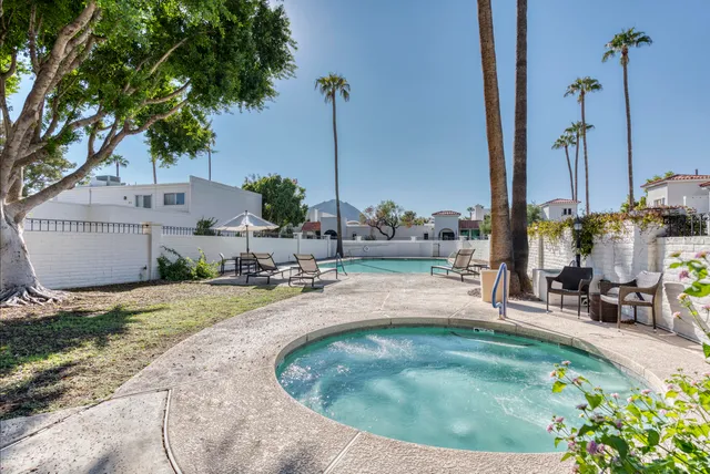 a view of a house with a backyard and sitting area