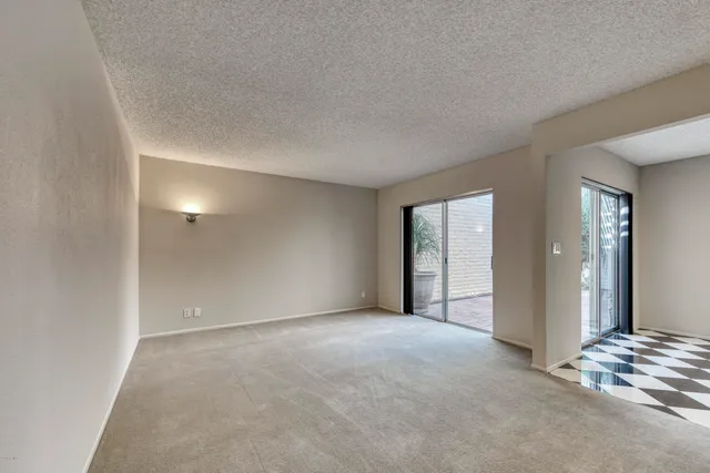 an empty room with windows and closet