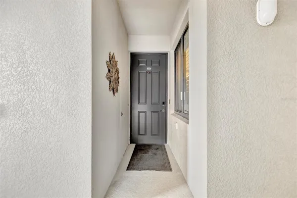a hallway with a view of living room with furniture