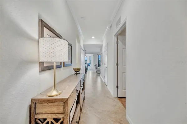 a kitchen with stainless steel appliances granite countertop wooden cabinets a stove a sink a dining table and chairs