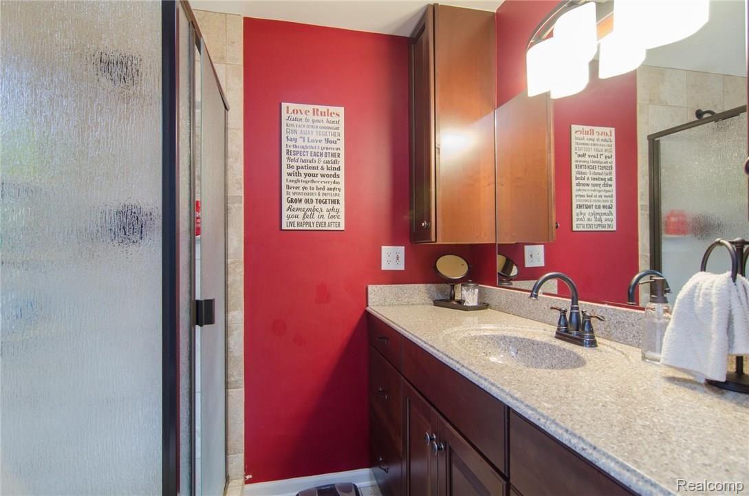 1461 Deerhurst Lane Rochester, MI 48307 - Photo 12 of 17 Remodeled Master Bath with maple cabinets, corian counter and ceramic tile!