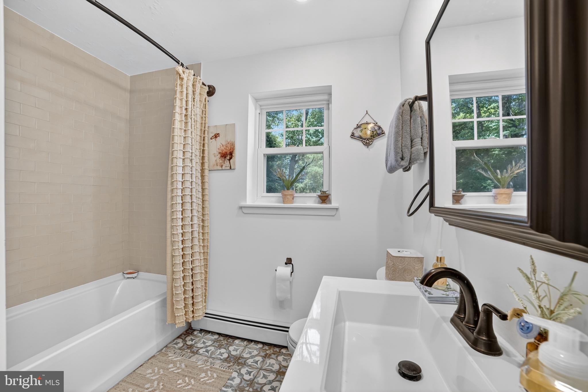 305 Irish Road Berwyn, PA 19312 - Photo 21 of 34 a bathroom with a sink a window and a bathtub