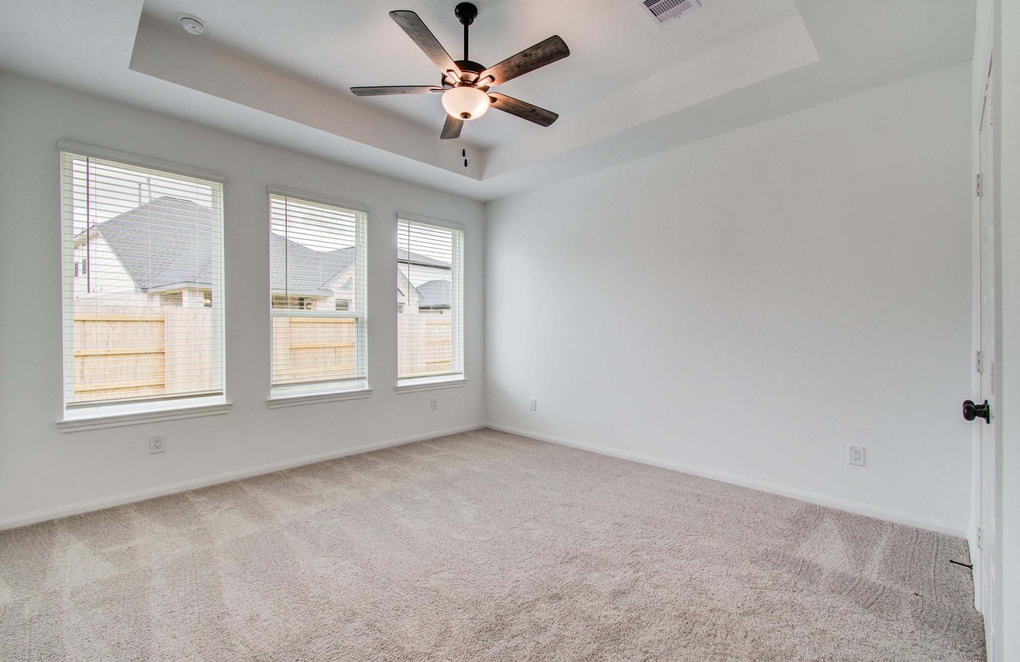 7231 Yarrow Blossom Court Katy, TX 77493 - Photo 25 of 49 an empty room with chandelier fan and windows