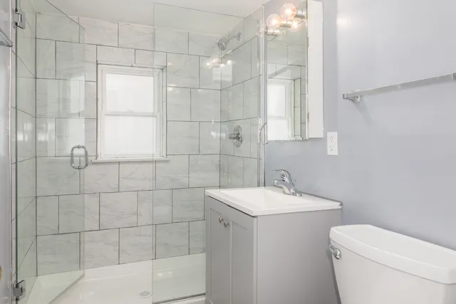 a bathroom with a sink toilet and shower