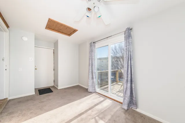a view of a room with a ceiling fan