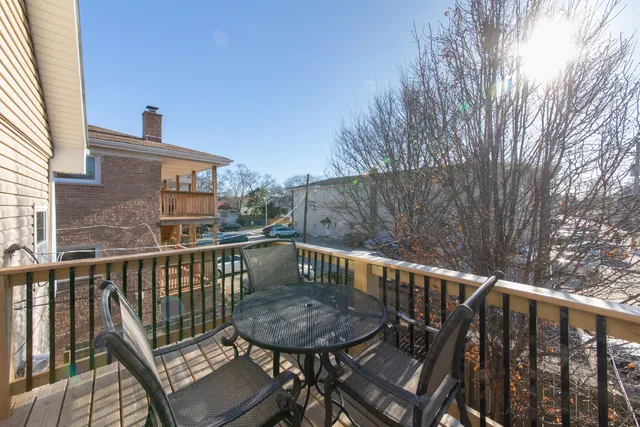 a view of a chair and table on the deck