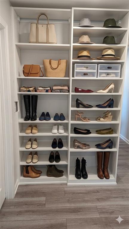 4830 Spangle Court Cumming, GA 30028 - Photo 16 of 18 a view of walk in closet with clothes and shoes