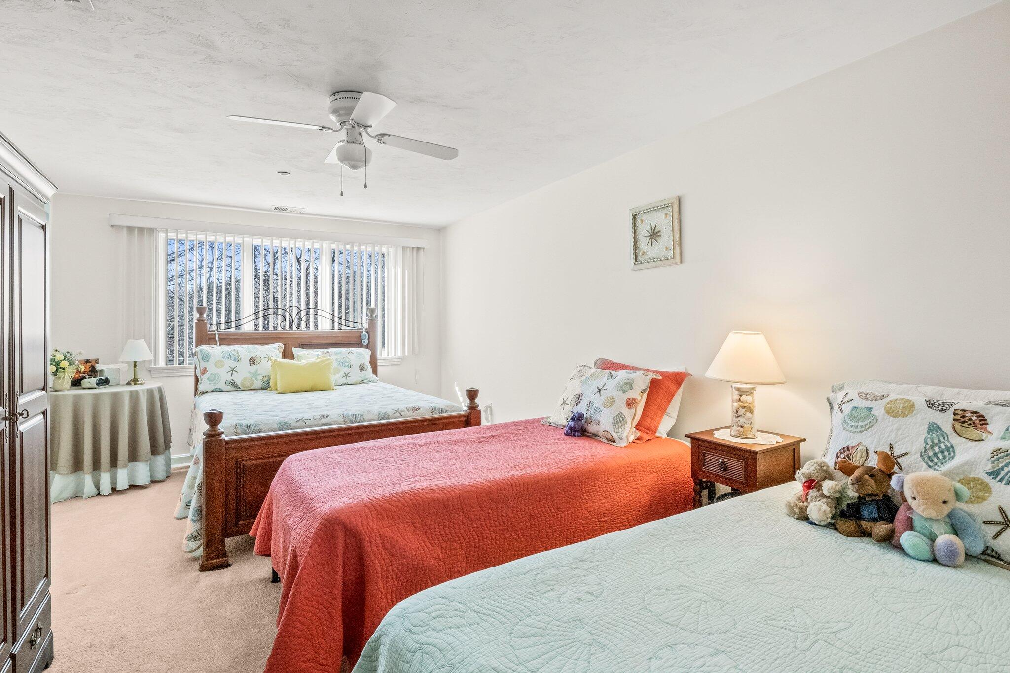 22 North Ridge Road Mashpee, MA 02649 - Photo 17 of 33 a bedroom with two beds and a chandelier