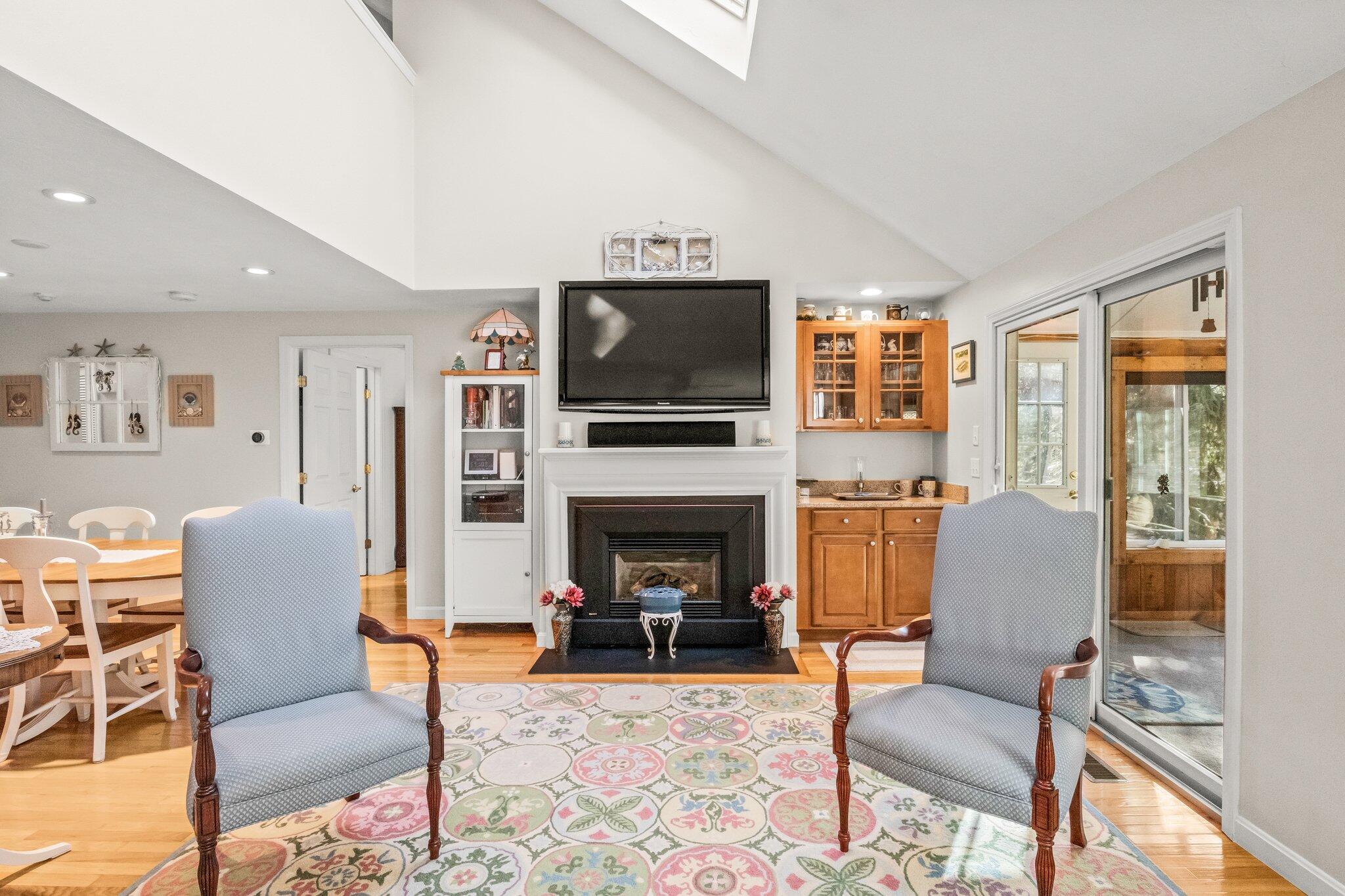 22 North Ridge Road Mashpee, MA 02649 - Photo 8 of 33 a living room with furniture a flat screen tv and a fireplace