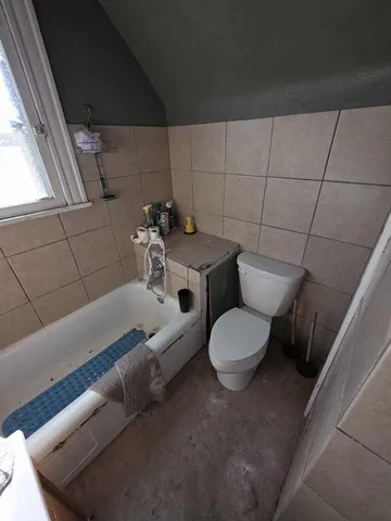 a kitchen with a table chairs stove and refrigerator