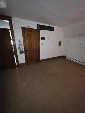 a living room with furniture wooden floor and a window