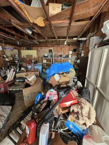 a view of a room with exposed pipes and a window