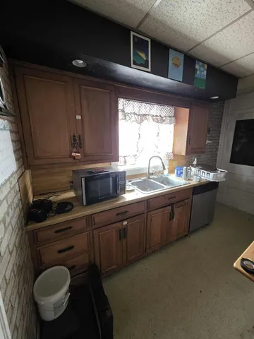 a kitchen with sink cabinets and window