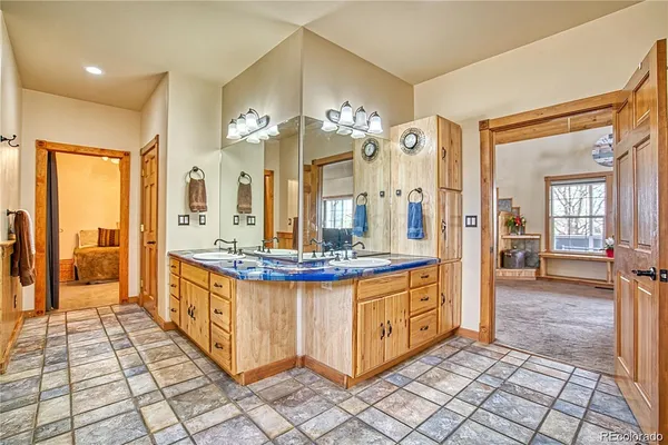 a view of a bathroom with sink shower and a mirror